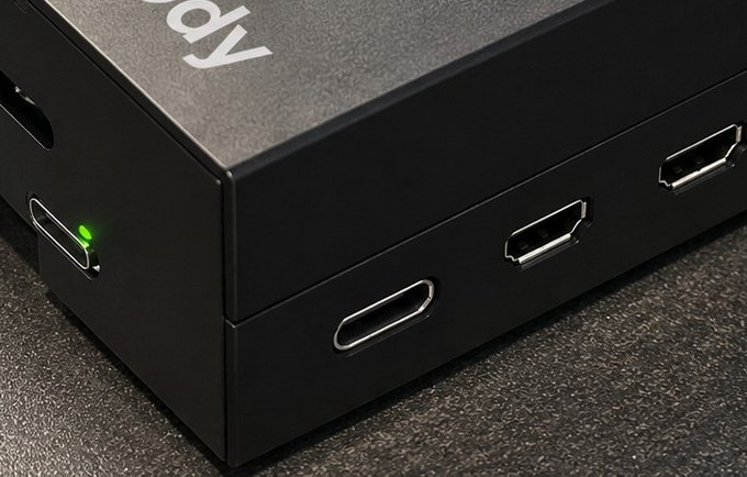 Close-up of Ody's green status light beside its USB-C power port