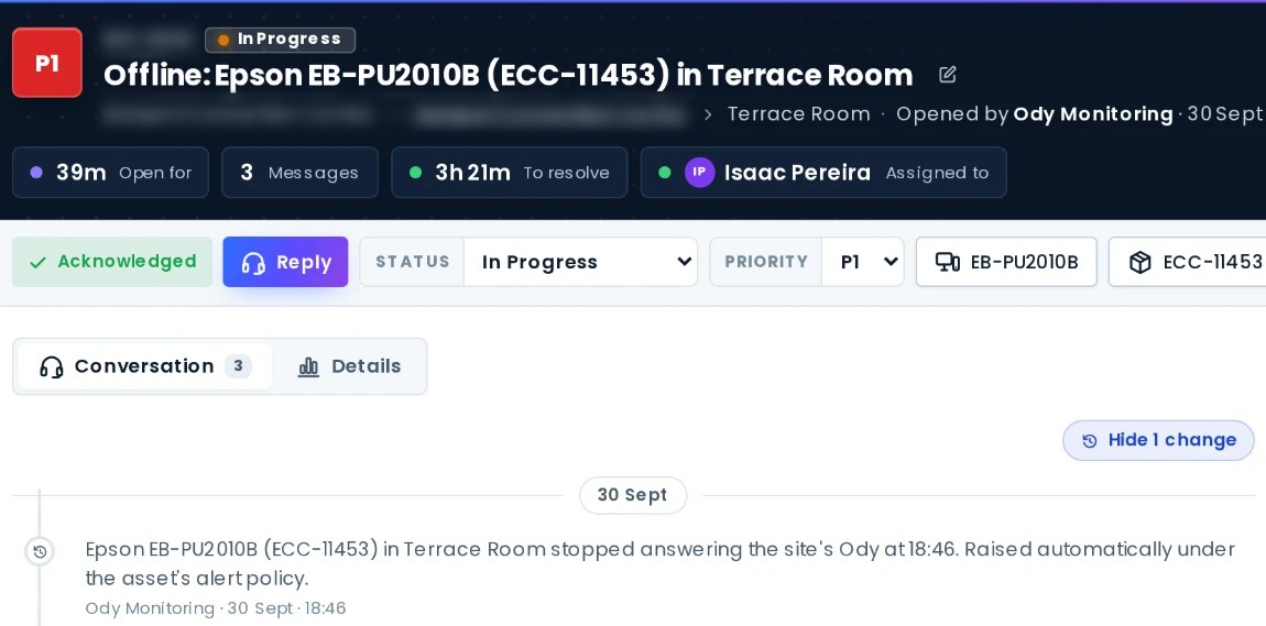 AVDesk priority-one ticket opened by Ody monitoring when a projector stopped answering: in progress, assigned, with its time to resolve and the automatic entry that raised it